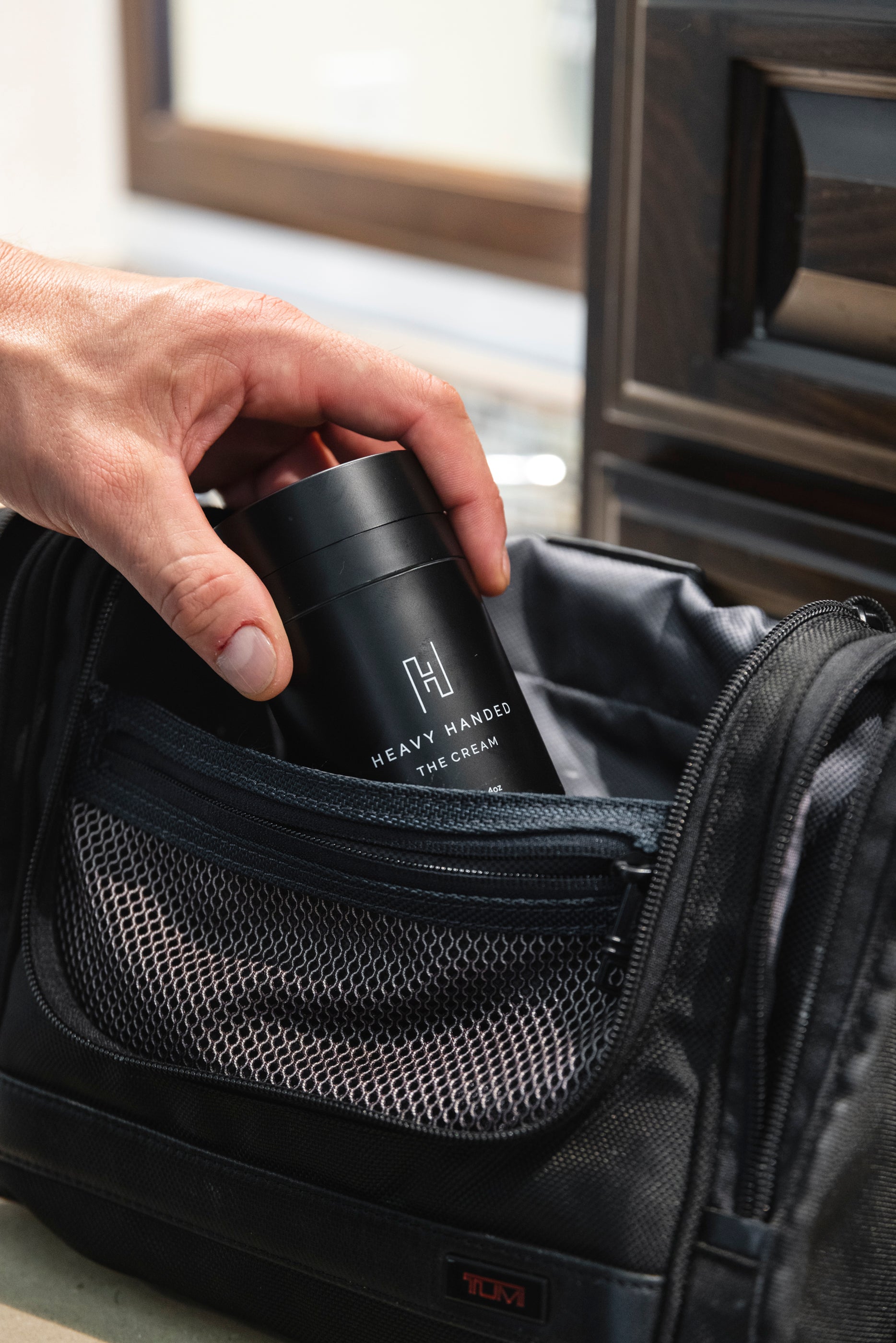 Athlete or crossfitter putting heavy handed hand cream in their workout bag. 